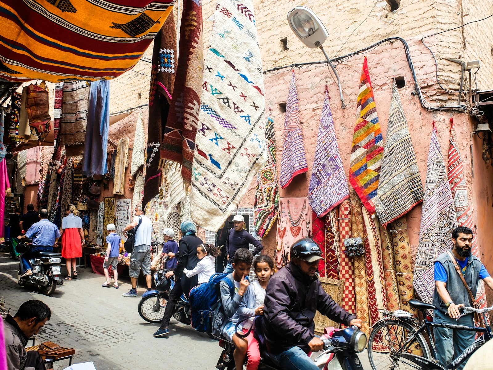 Traditional souk in Marrakech with colorful lanterns and textiles